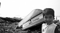 South India: Watered Down The hull is splintered. Upside down. And forgotten. The remains of the tiny fishing vessel clutter the shore, but like the beauty of a colorfully abandoned conch, it continues to...